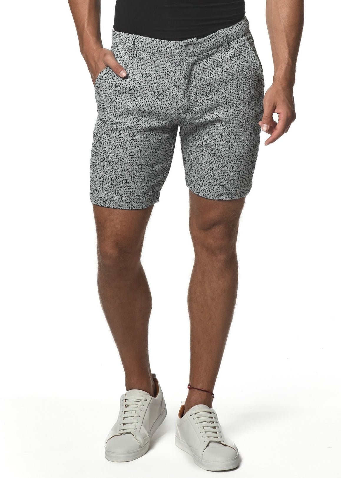 A man wearing a black V-neck t-shirt and grey jacquard shorts with an 8-inch inseam, standing against a white background.