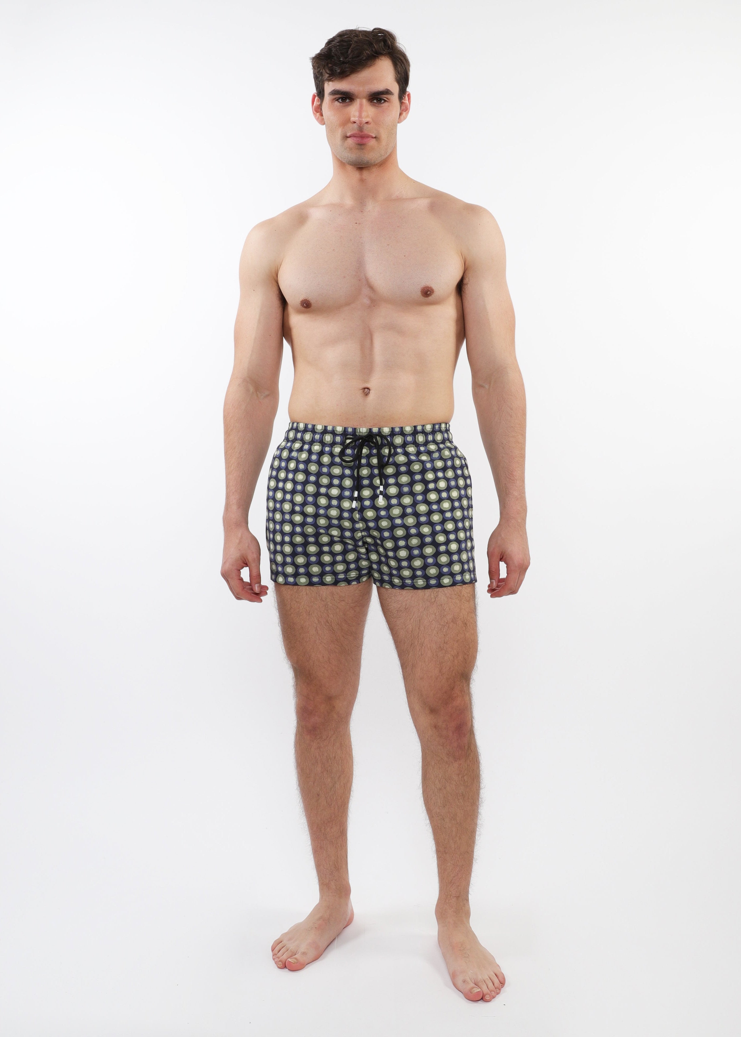 Man wearing black and white checkered boxer shorts on a white background