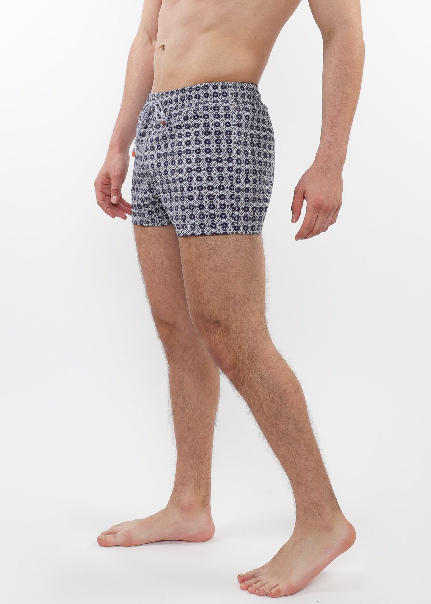 Man wearing patterned boxer shorts on a white background