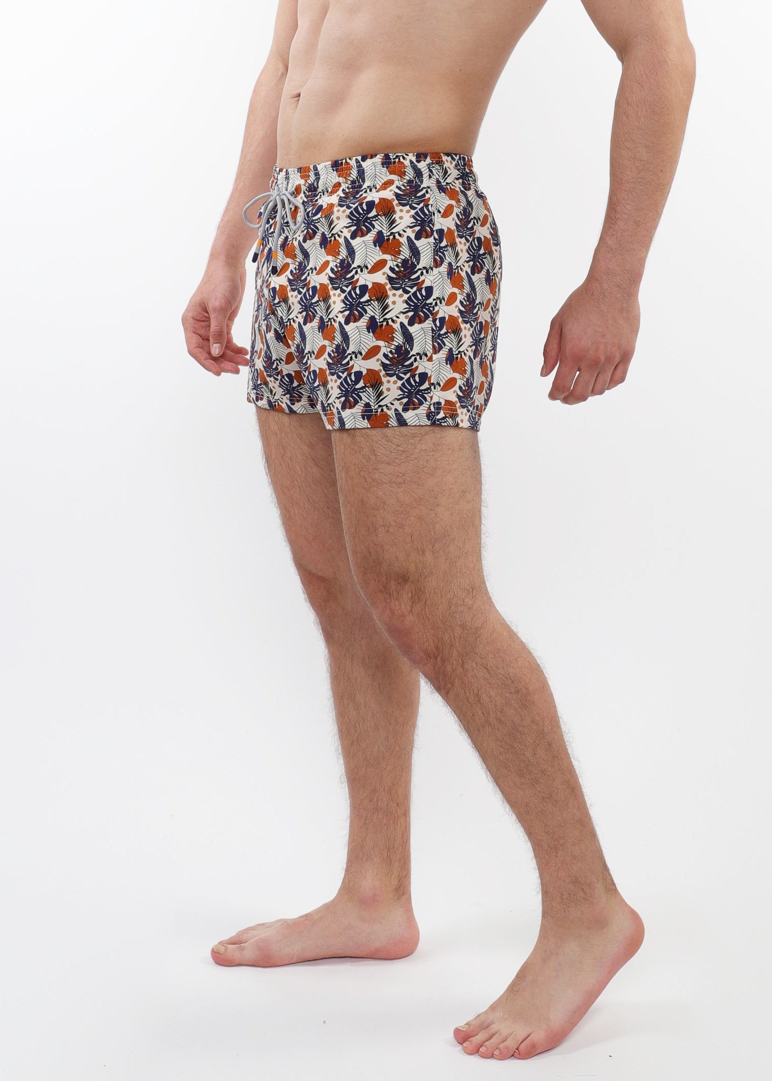 Man wearing a patterned swimsuit on a white background