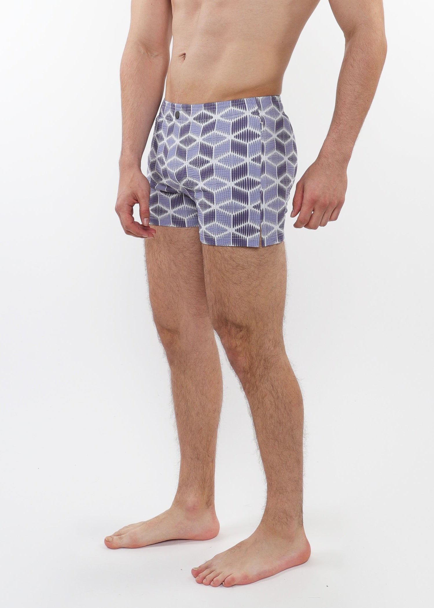 Person wearing patterned swim shorts on a white background