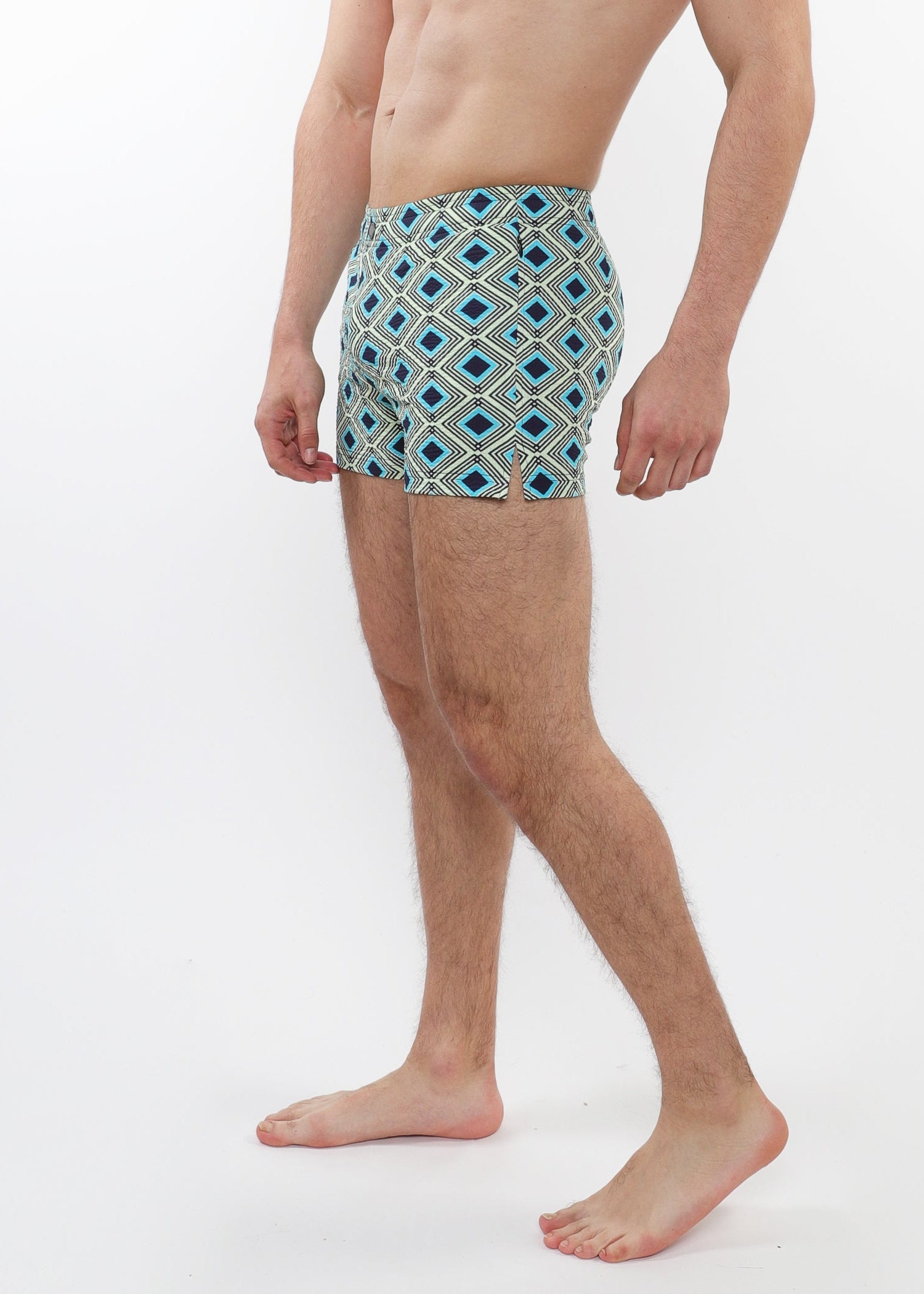 Person wearing patterned swim shorts on a white background