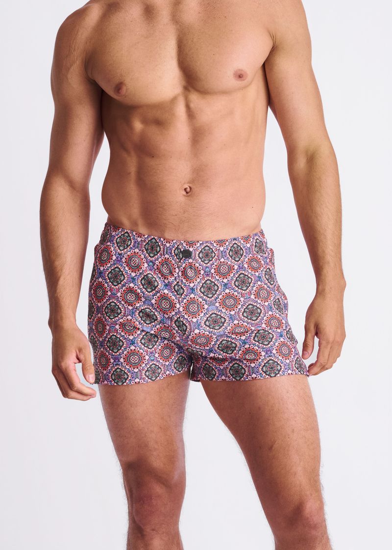 Man wearing patterned underwear on a plain background